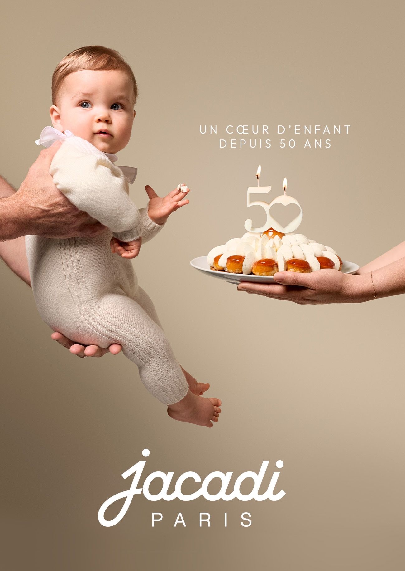 baby wearing a cashemer set ready to bloaw the 50 years cake candles for Jacadi