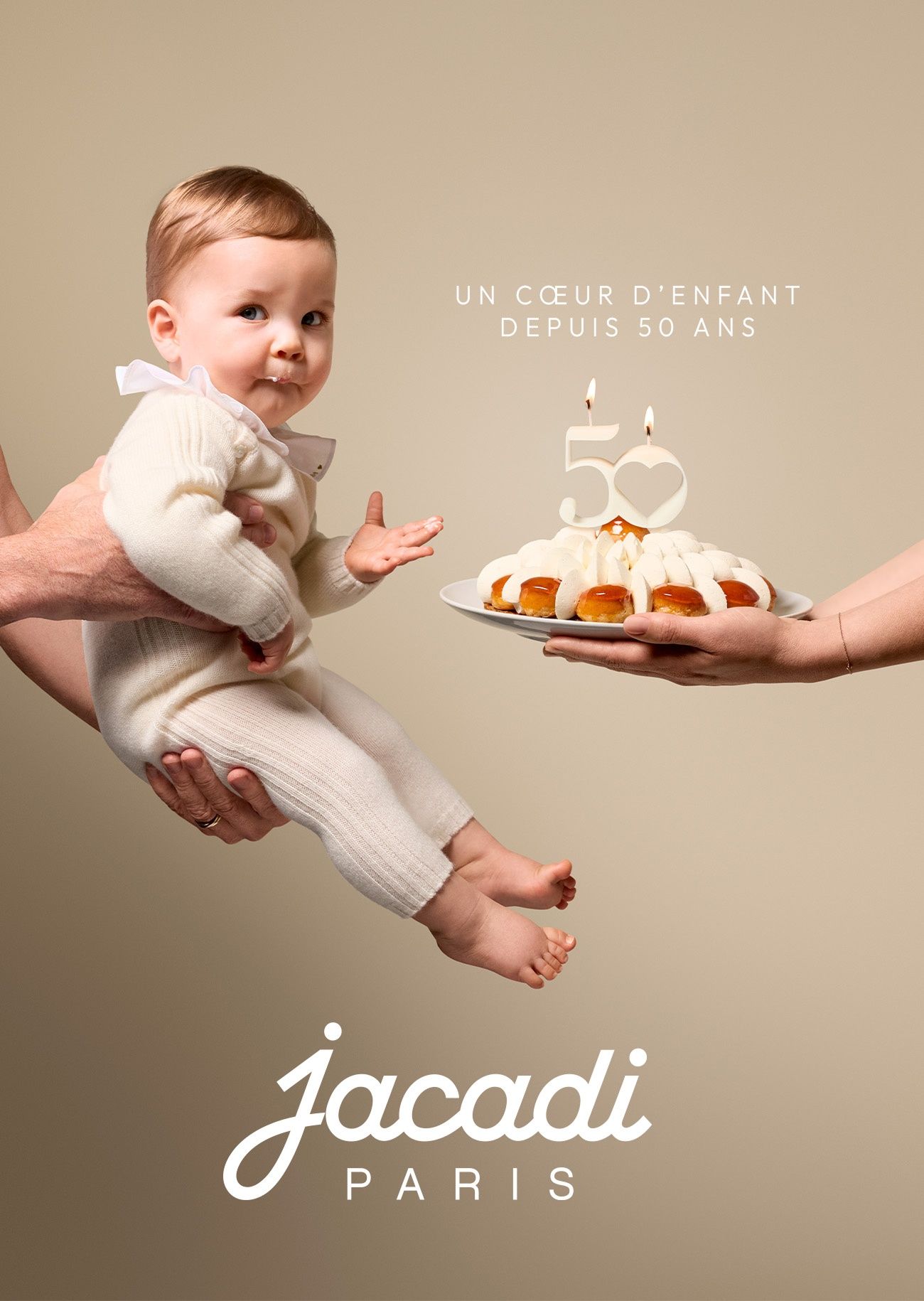 Baby dressed in a cashmere set tasting the cake